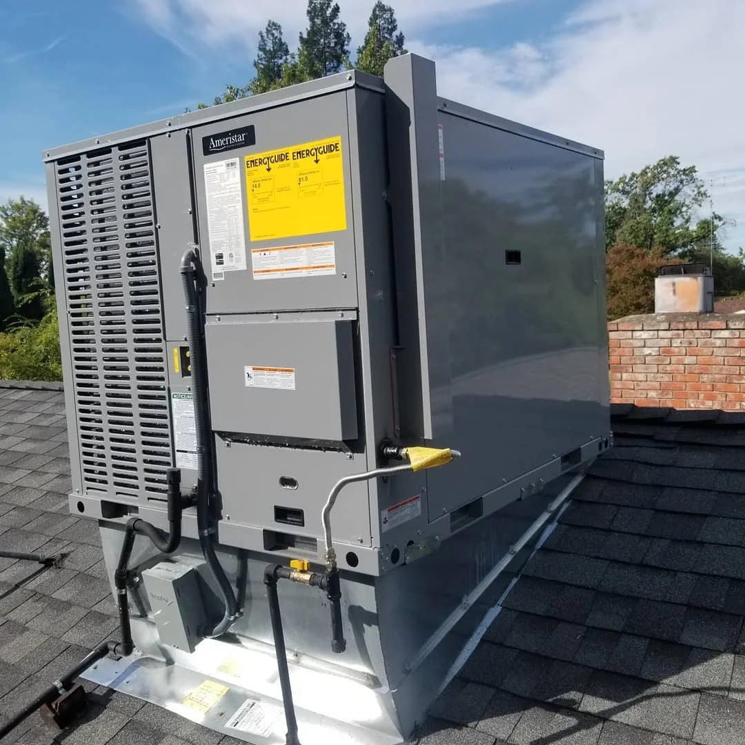 Ameristar heat pump unit installed on rooftop with metal mounting platform and electrical connections